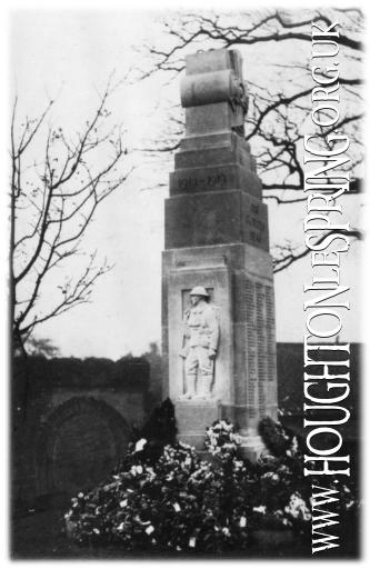 Flowers stacked high in front of Houghton-le-Spring Cenotaph