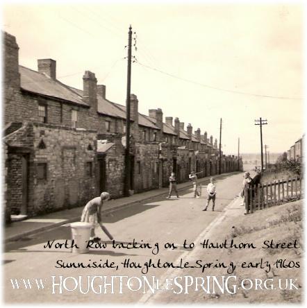 A game of cricket on Hawthorn Street, with the back yards of North Row opposite