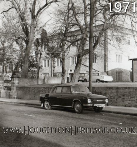 A car passes the front of Houghton Hall in 1971