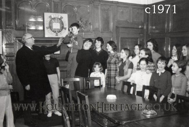 Mr John Edwards, Chairman of Houghton YMCA, giving out prizes and awards in the Boardroom at Houghton Hall, circa 1971