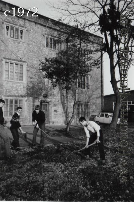 Young lads tidying up the front garden of the YMCA at Houghton Hall, guessed to be around 1972