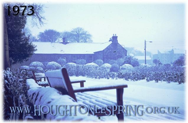 The Rose Garden covered in snow, 1973.  The Old Tithe Barn, then in use as the Rectory, can be seen in the background