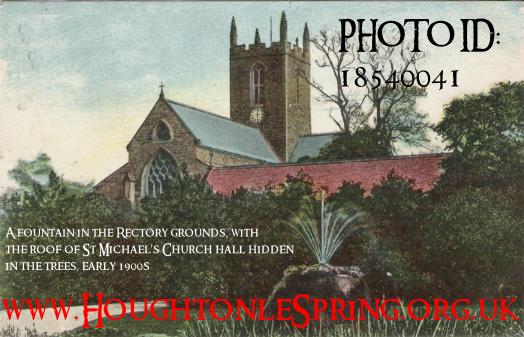 Houghton Rectory fountain, with the roof of St Michael's Church Hall just visible through the trees, early 1900s