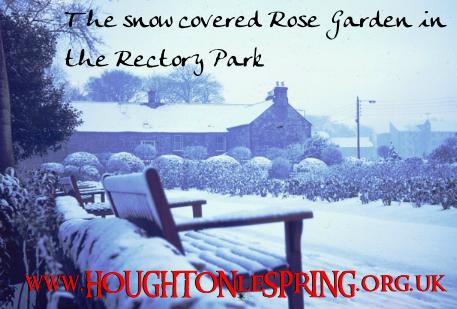 The snow covered Rose Garden in Rectory Park with the new Rectory (Old Tithe Barn) in the background, 1973